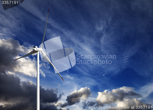 Image of Wind turbine and blue sky with storm clouds