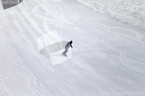 Image of Ski slope and snowboarder at sun day