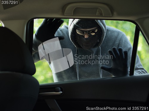 Image of Transportation crime concept .Thief stealing bag from the car