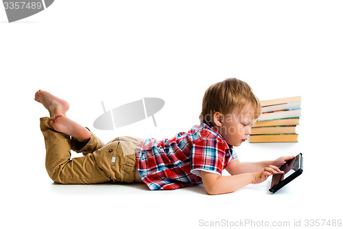 Image of small boy with tablet computer and books