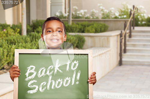 Image of Boy Holding Back To School Chalk Board on School Campus
