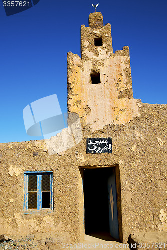 Image of old brown construction in africa     near the tower