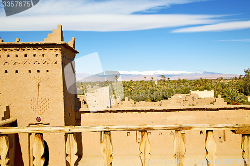 Image of brown old  construction in  africa   tower snow palm tree