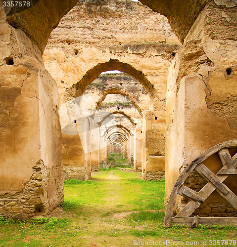 Image of old moroccan granary in the green grass and archway  wall