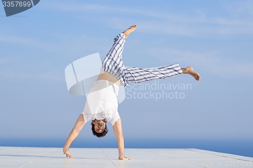 Image of young man practicing yoga