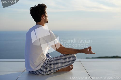 Image of young man practicing yoga