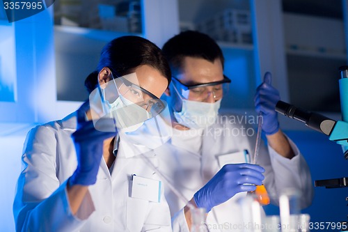 Image of close up of scientists making test in lab