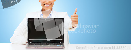 Image of smiling woman with laptop computer