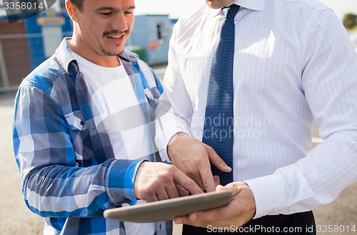 Image of close up of builder and businessman with tablet pc