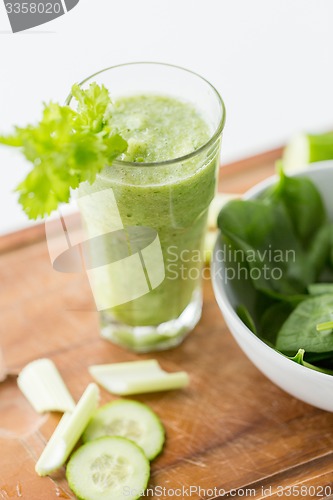 Image of close up of fresh green juice glass and celery