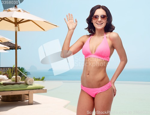 Image of happy woman in sunglasses and bikini swimsuit