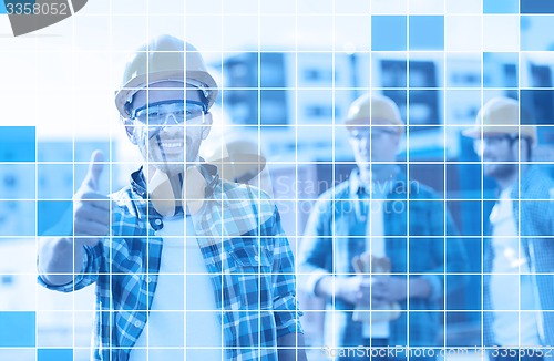 Image of group of smiling builders in hardhats outdoors