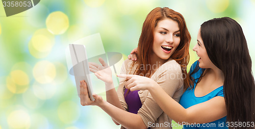 Image of two smiling teenagers with tablet pc computer