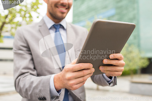Image of close up of business man with tablet pc in city