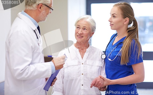 Image of medics and senior patient woman at hospital