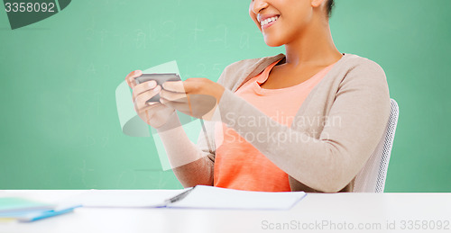 Image of afro american student girl with smartphone