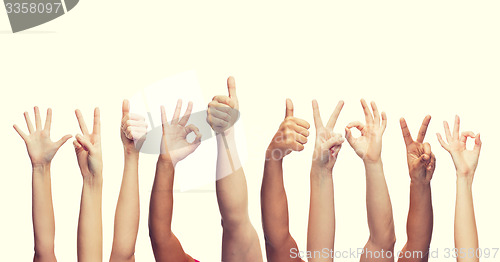 Image of human hands showing thumbs up, ok and peace signs