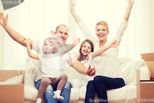 Image of smiling parents and two little girls at new home