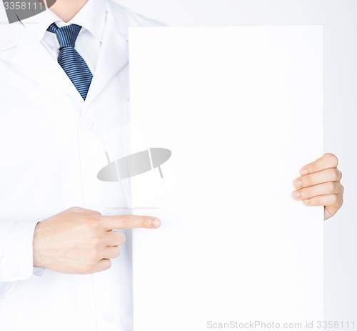 Image of doctor holding blank white banner