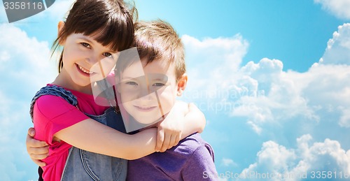 Image of two happy kids hugging over blue sky and clouds