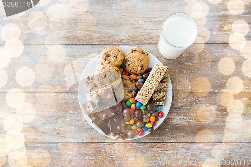 Image of close up of sweet food and milk glass on table