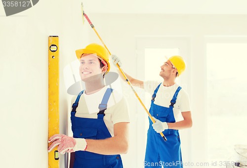 Image of group of builders with tools indoors