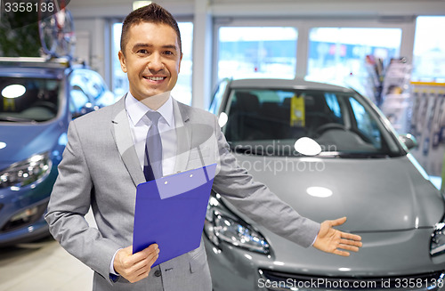 Image of happy man at auto show or car salon