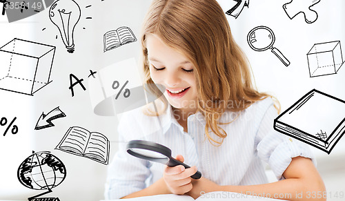 Image of girl reading book with magnifier at school