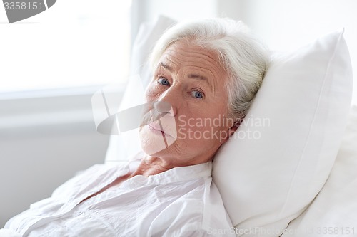 Image of senior woman patient lying in bed at hospital ward