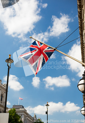 Image of union jack flag waving on london city street