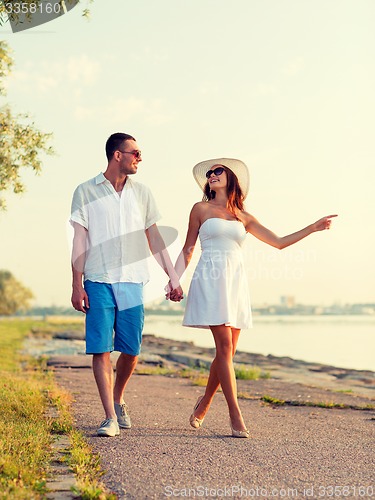 Image of smiling couple walking outdoors
