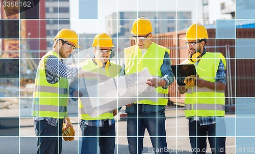 Image of builders in hardhats and vests with blueprint