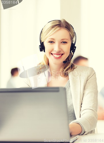 Image of helpline operator with headphones in call centre