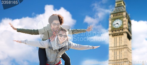 Image of happy teenage couple having fun over big ben tower