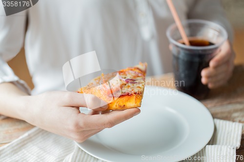 Image of close up of woman with pizza and coca cola drink