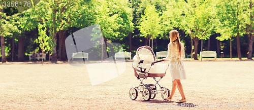 Image of happy mother with stroller in park