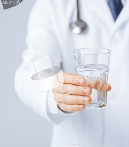 Image of doctor hands giving glass of water