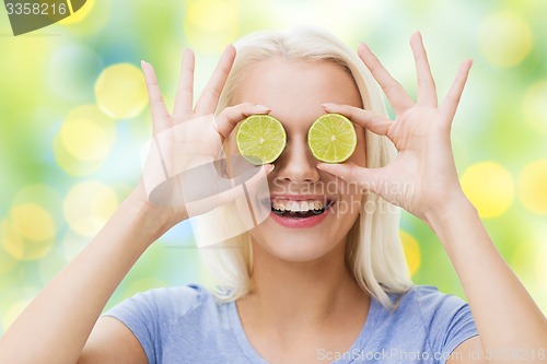 Image of happy woman having fun covering eyes with lime