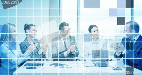 Image of business team with laptop clapping hands