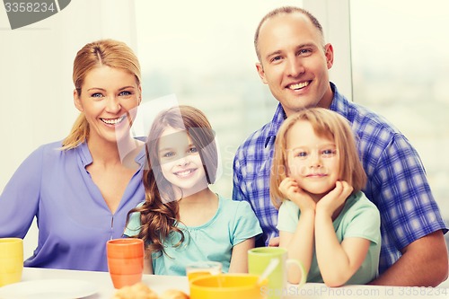 Image of happy family with two kids with having breakfast