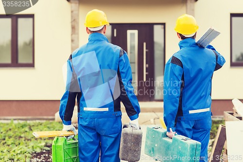 Image of group of builders with toolboxes