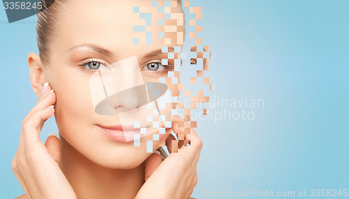 Image of beautiful young woman touching her face