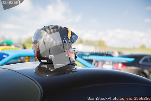 Image of close up of car with helmet on roof top