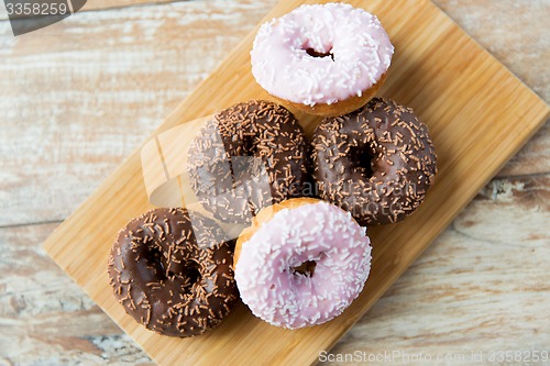 Image of close up of glazed donuts pile on table
