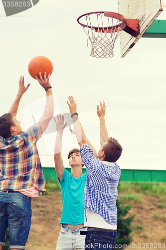 Image of group of teenagers playing basketball