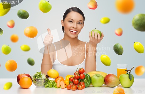 Image of happy woman with healthy food showing thumbs up