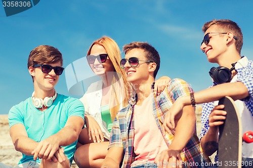 Image of group of smiling friends sitting on city street