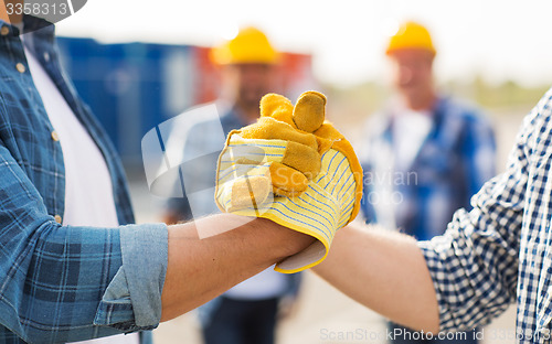 Image of close up of builders hands making handshake