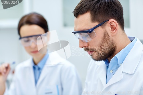 Image of close up of young scientists at laboratory