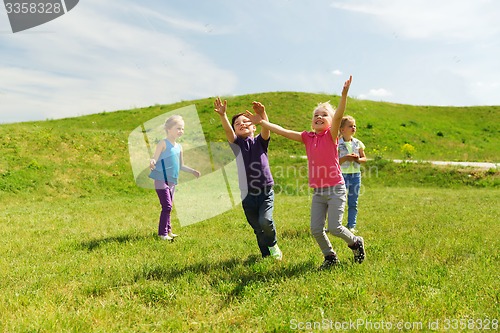 Image of group of happy kids running outdoors